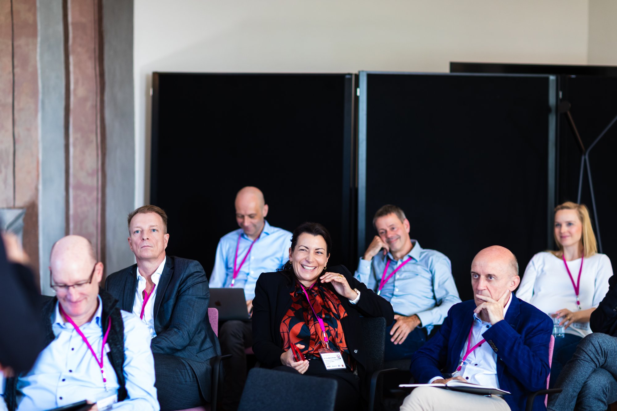 Dr. Eva-Maria Hempe smiling in the audience of Software als Management-Task in Schloss Fürstlich Drehna